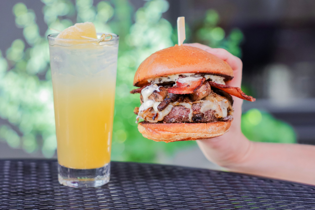 Held up American Burger with Lemonade